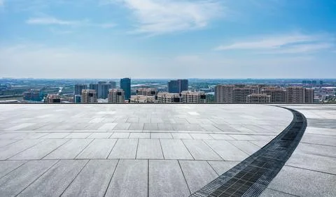 Empty square floor and city skyline with modern buildings scenery. Stock Photos