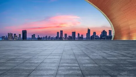 Empty square floor and city skyline with modern buildings at sunset in Shanghai Stock Photos