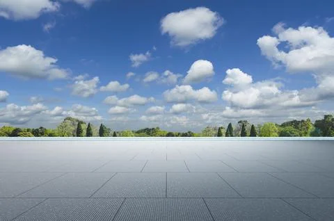 Empty square floor and green forest landscape with cloudy sky Foto stock