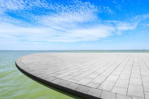 Empty square floor and lake landscape under the blue sky. Stock Photos