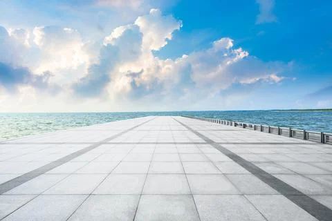 Empty square floor and lake with beautiful clouds. Stock Photos