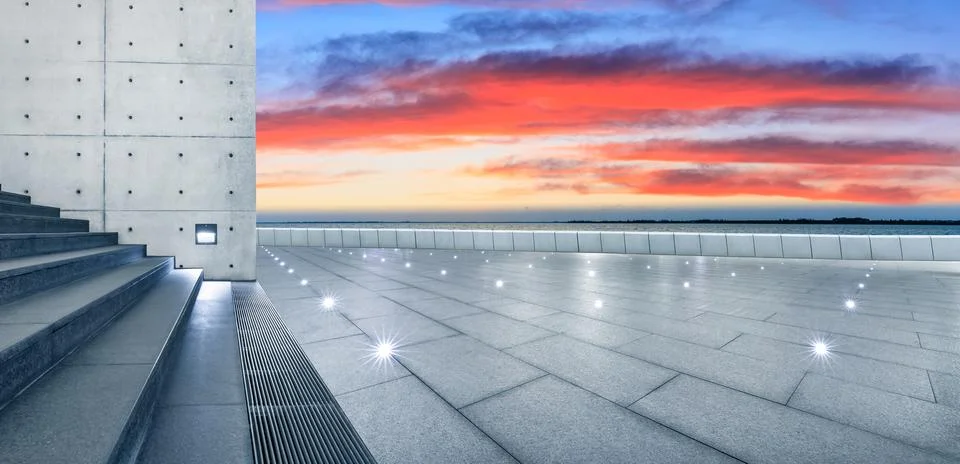 Empty square floor and lake with beautiful clouds at sunset. Stock Photos