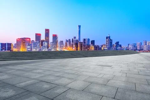 Empty square floor and modern city commercial buildings in Beijing at night. Stock Photos