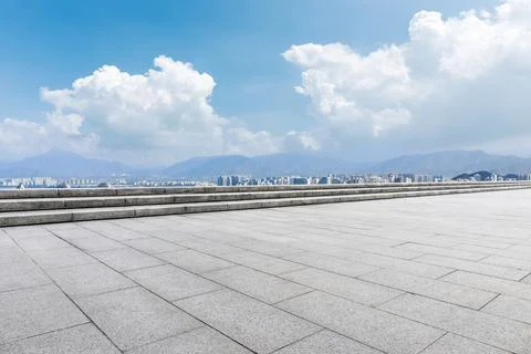 Empty square floor and modern city commercial building with skyline. Stock Photos