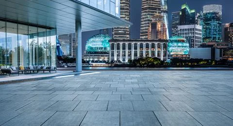 Empty square floor and modern city buildings in Shanghai at night. Stock Photos