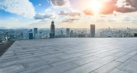 Empty square floor and modern city skyline with buildings at sunset in Ningbo Stock Photos