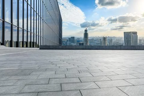 Empty square floor and modern city skyline with buildings at sunset in Ningbo Stock Photos