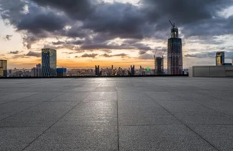 Empty square floor and modern city skyline with buildings at sunset in Ningbo Stock Photos
