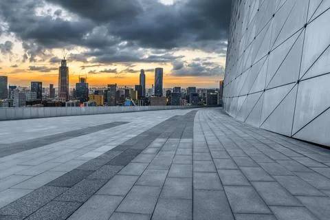Empty square floor and modern city skyline with buildings at sunset in Ningbo Stock Photos