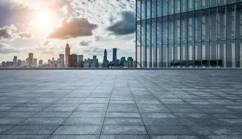 Empty square floor and modern city skyline with buildings at sunset in Ningbo Stock Photos