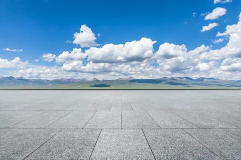 Empty square floor and mountain under blue sky. Stock Photos