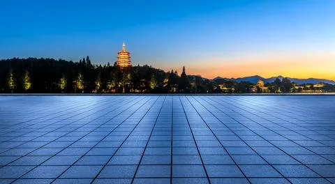 Empty square floor and mountain with tower scenery in Hangzhou at sunset. Stock Photos