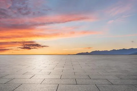 Empty square floor and mountains at sunrise. Stock Photos