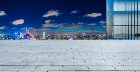 Empty square floor and Shanghai skyline with buildings at night. Stock Photos
