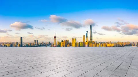 Empty square floor and Shanghai skyline with buildings at sunset. Stock Photos