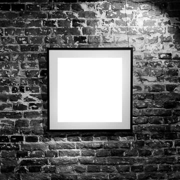 Empty square frame on black brick wall. Blank space poster or art frame waiti Stock Photos