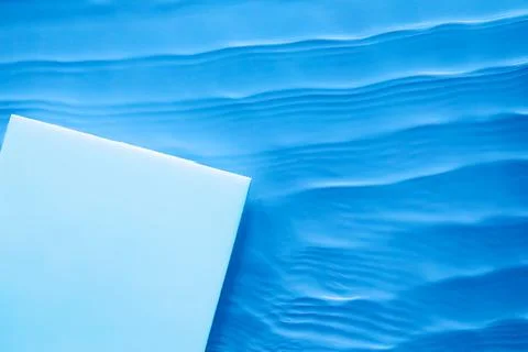 Empty square podium on transparent blue water background Stock Photos