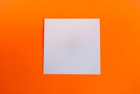 An empty square white composition on a bright orange background.Minimalism st Stock Photos