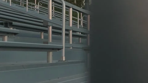 Empty stadium bleachers with reverse reveal ending behind support pole 動画素材 338086194