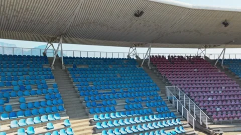 Empty Stadium Grandstand With Workers Preparing Dirt Field Below Seating Stock Footage 346653954