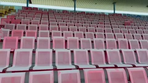 Empty stadium grandstands with rows of red and yellow seats Vidéo 332580141