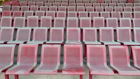 Empty stadium seating with red and yellow rows overhead with stadium seats Видео 332580142
