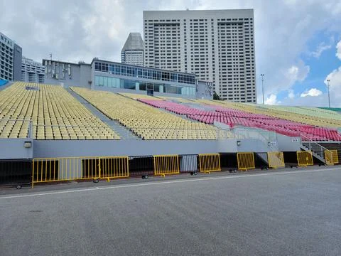 Empty stadium seats in vibrant yellow and pink hues Stock Photos