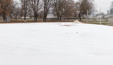 Empty stadium, treadmill, paved, with markings for runner athletes. Winter .. Stock Photos