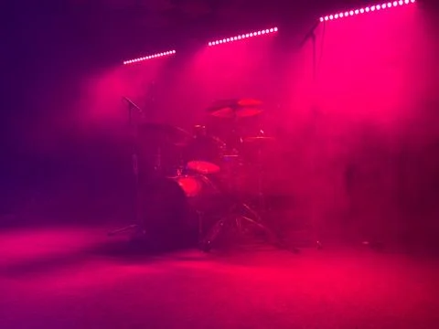 Empty stage with drum kit bathed in red light Stock Photos