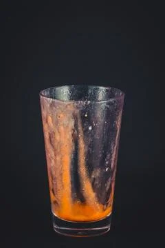 Empty stained drinking glass on black Foto stock