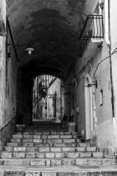 An empty staircase leading through a passage, somewhere in downtown Matera, S Stock Photos