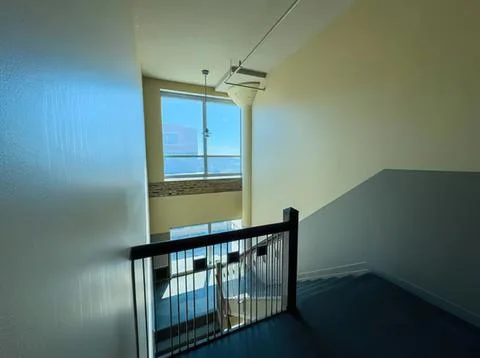Empty stairwell with large window and sunlight Stock Photos