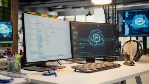 Empty startup office with artificial intelligence program running on PC monitors 库存照片
