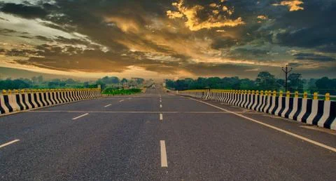 Empty state highway with a dramatic sky in the evening Stock Photos