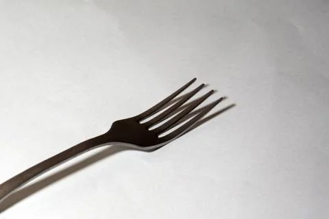 Empty Steel Fork on white background. Selective soft focus. Stock Photos