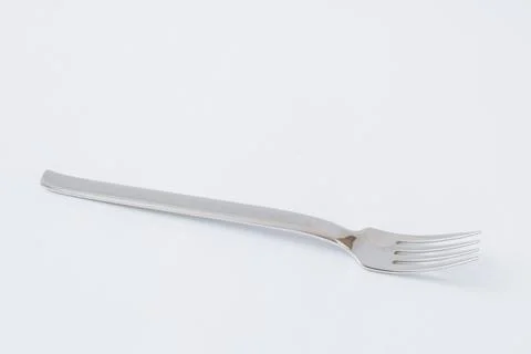 Empty steel fork on white background, copy space Stock Photos