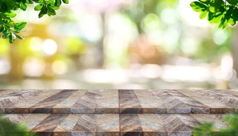 Empty step plank wood table top with blur tree in park with bokeh light backg Stock Photos