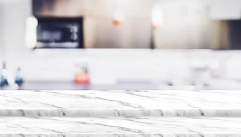 Empty step white marble table top food stand with blur house kitchen backgrou Stock Photos