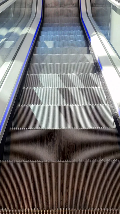 Empty steps of an escalator in a persons point of view. 動画素材 244352126