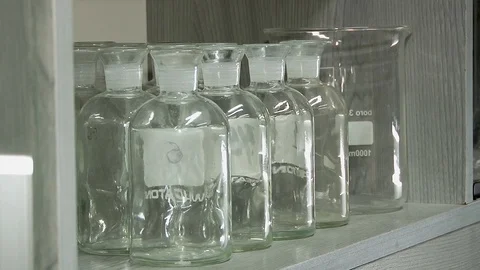 Empty sterile laboratory bottles on a shelf. Stock Footage 127321014