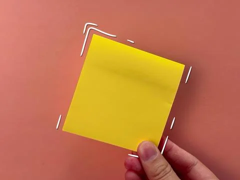 An empty sticker for notes. the hand holds a piece of paper. an empty bubble  Stock Photos