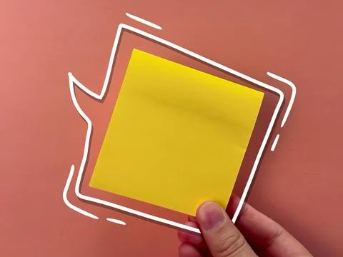 An empty sticker for notes. the hand holds a piece of paper. an empty bubble  Stock Photos