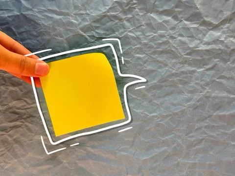 An empty sticker for notes. the hand holds a piece of paper. an empty bubble  Stock Photos
