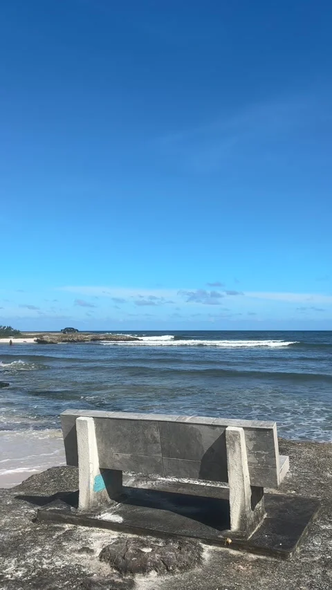 Empty Stone Bench Facing Ocean Waves at Barbados Beach Stock Footage 337972271