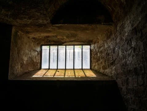 Empty stone room with barred window light Stock Photos