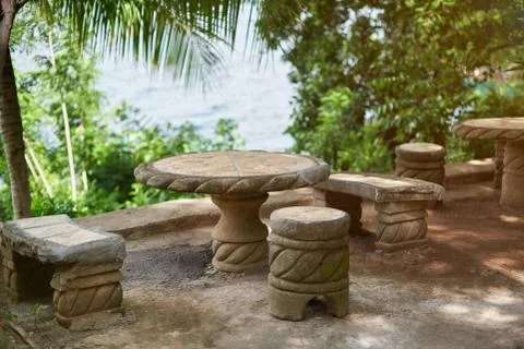Empty stone table with chairs Stock Photos