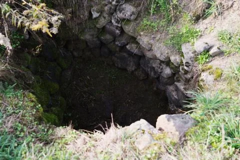 Empty stone well - drought. Stock Photos