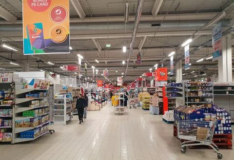 An empty store with many shelves full of products in it 스톡 사진