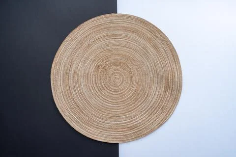 Empty straw table mat on black and white background table. Stock Photos