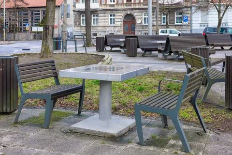 Empty street chess table and benches in a city park. Playing chess on the s.. Stock Photos